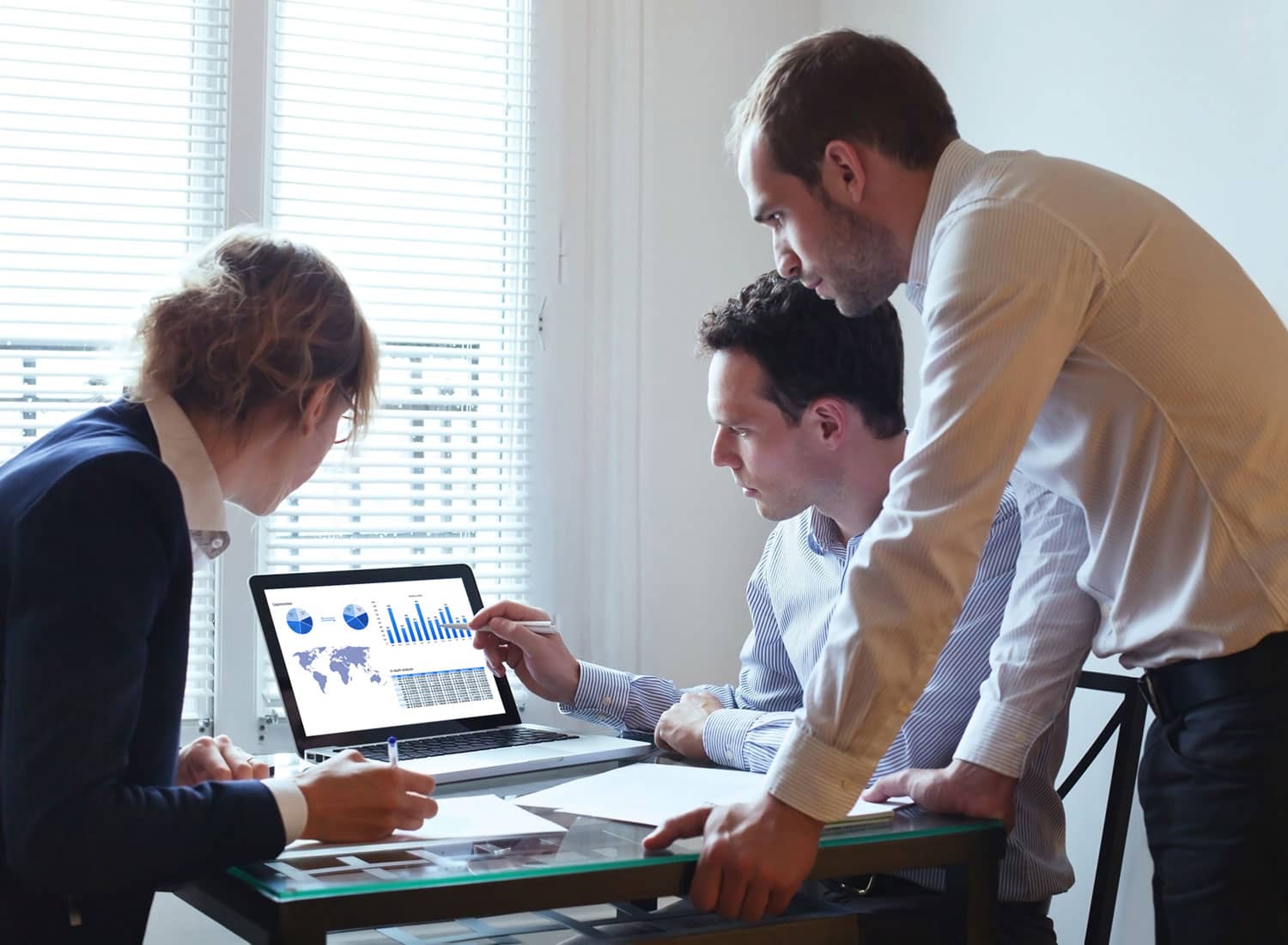 Business Team of 3 Working on Economic Report