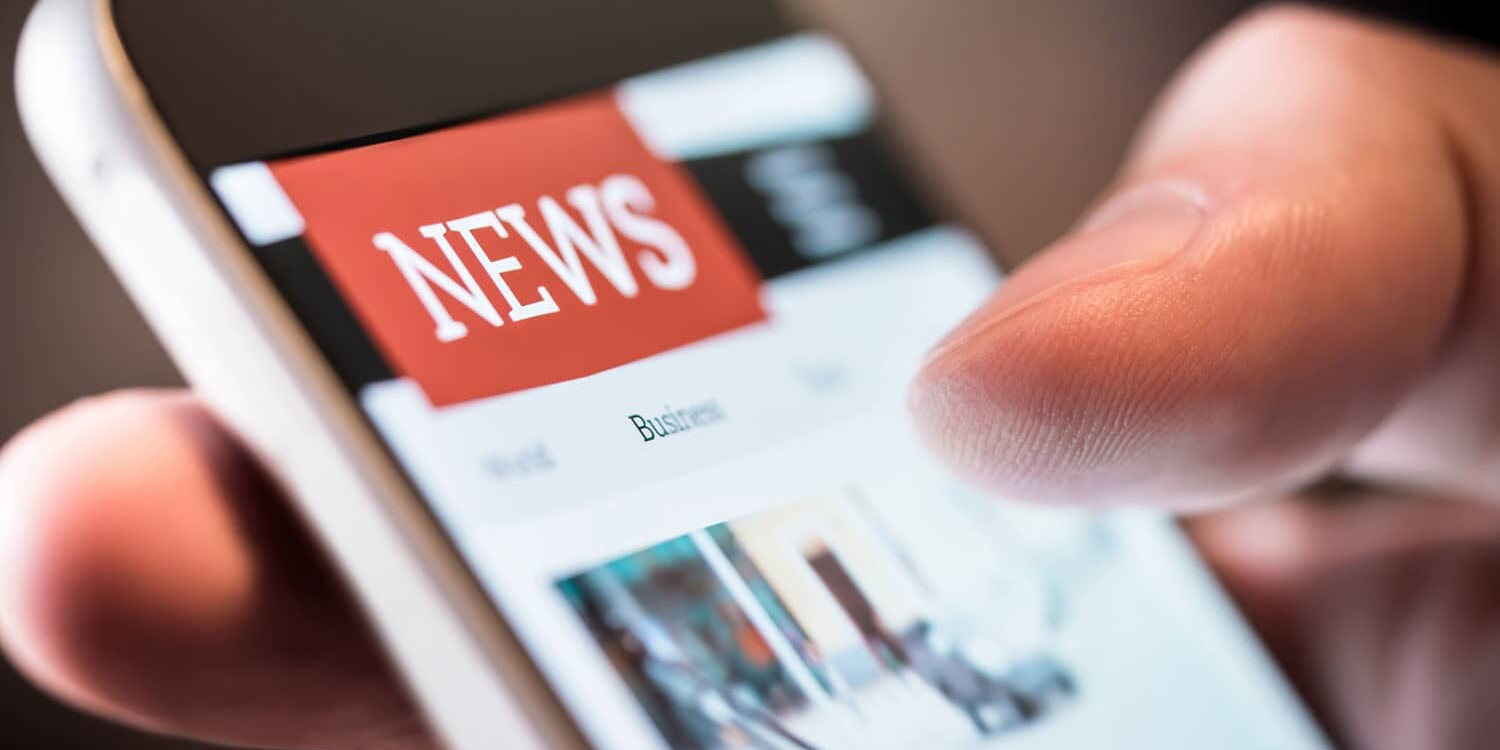 Online news in mobile phone. Close up of smartphone screen.